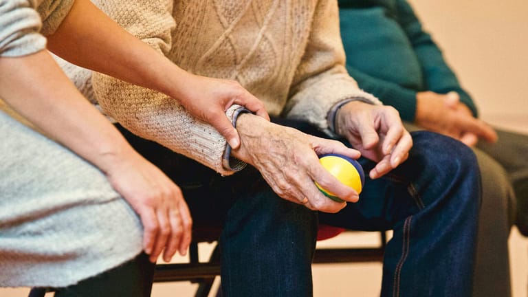 Young hands help elderly hands.